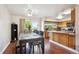 Cozy dining area with hardwood floors, a ceiling fan, and access to the outdoor deck at 848 S 13Th Ave, Brighton, CO 80601