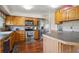 Functional kitchen with wooden cabinets, stainless steel appliances, and hardwood floors at 848 S 13Th Ave, Brighton, CO 80601