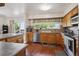 Well-lit kitchen featuring wooden cabinets, stainless steel appliances, and a breakfast bar at 848 S 13Th Ave, Brighton, CO 80601