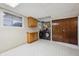 Functional laundry room with washer, dryer, storage cabinets, and folding counter at 848 S 13Th Ave, Brighton, CO 80601