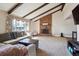 Inviting living room with vaulted ceilings, exposed beams, and a cozy brick fireplace at 848 S 13Th Ave, Brighton, CO 80601