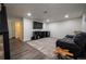 Finished basement with comfortable seating area, modern entertainment center, and wood laminate flooring at 4673 S Lowell Blvd, Denver, CO 80236