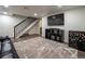 Finished basement with TV, shelving and refrigerator at 4673 S Lowell Blvd, Denver, CO 80236