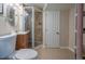 Bathroom features a stand up shower with tiled walls, a sink with a wood cabinet, and tile flooring at 4673 S Lowell Blvd, Denver, CO 80236