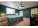 Bedroom features large bed, ceiling fan, two closets and two bedside tables at 4673 S Lowell Blvd, Denver, CO 80236