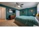 Bedroom features large bed, TV, bureau, and adjacent bathroom at 4673 S Lowell Blvd, Denver, CO 80236