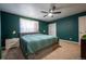 Stylish bedroom with a plush bed, elegant lamps, and a five-blade ceiling fan at 4673 S Lowell Blvd, Denver, CO 80236