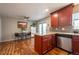 Open-concept kitchen and dining area with granite countertops and stainless steel appliances at 4673 S Lowell Blvd, Denver, CO 80236
