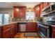 Well-appointed kitchen featuring stainless steel appliances and stylish dark wood cabinetry at 4673 S Lowell Blvd, Denver, CO 80236