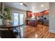 Updated kitchen featuring stainless steel appliances, granite countertops, and rich hardwood flooring at 4673 S Lowell Blvd, Denver, CO 80236