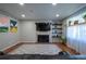 Bright living room featuring a fireplace, large TV, and comfortable seating, creating an inviting atmosphere at 4673 S Lowell Blvd, Denver, CO 80236