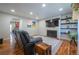 Living room with black leather sofa, hardwood floors, fireplace, and television at 4673 S Lowell Blvd, Denver, CO 80236