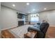 Spacious living room with modern fireplace, sleek TV, and cozy seating, ideal for relaxing and entertaining at 4673 S Lowell Blvd, Denver, CO 80236
