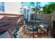 Outdoor patio with colorful rug, table, chairs, and partial shade from an umbrella at 4673 S Lowell Blvd, Denver, CO 80236