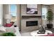 Cozy living room showcases a modern fireplace, neutral decor, and natural light for a relaxing atmosphere at 9186 Telluride Ct, Commerce City, CO 80022