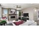 Inviting living room features a tiled fireplace, modern ceiling fan, and neutral tones that create a welcoming ambiance at 9186 Telluride Ct, Commerce City, CO 80022