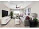Stylish living area includes a comfy sectional, modern decor, and a large screen TV for ultimate relaxation at 9186 Telluride Ct, Commerce City, CO 80022