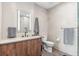 Contemporary bathroom with wood vanity, illuminated mirror, and a separate toilet space at 1901 Wazee St # 504, Denver, CO 80202