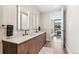 Contemporary bathroom with double sinks, sleek fixtures, wood cabinets, modern tile flooring and access to bedroom at 1901 Wazee St # 504, Denver, CO 80202