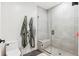Modern bathroom features a glass enclosed shower, grey tile, toilet, and plush rug at 1901 Wazee St # 504, Denver, CO 80202