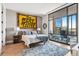 Charming bedroom boasts natural light, balcony access, rustic nightstands, and a modern rug at 1901 Wazee St # 504, Denver, CO 80202