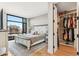 Bright bedroom featuring a large window, a walk-in closet, and hardwood floors at 1901 Wazee St # 504, Denver, CO 80202