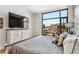 Bedroom featuring ample natural light, a cozy bed, and a modern dresser for storage at 1901 Wazee St # 504, Denver, CO 80202