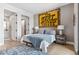 Inviting bedroom with unique wall art, natural light, and ensuite bathroom at 1901 Wazee St # 504, Denver, CO 80202