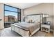 Bedroom with large windows offering city views, neutral decor, and a cozy, inviting atmosphere at 1901 Wazee St # 504, Denver, CO 80202