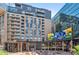Exterior view of a mixed-use development with outdoor seating and digital billboards at 1901 Wazee St # 504, Denver, CO 80202