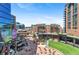 An expansive exterior shot of the common area featuring dining and recreation, as well as multiple high rise buildings at 1901 Wazee St # 504, Denver, CO 80202