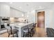 Bright kitchen featuring a marble island, pendant lighting, modern appliances, and wood door at 1901 Wazee St # 504, Denver, CO 80202