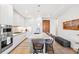 Contemporary kitchen featuring sleek white cabinets, stainless appliances, and a marble countertop island at 1901 Wazee St # 504, Denver, CO 80202