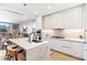 Open kitchen with a large quartz island, pendant lights, modern cabinets, and stainless appliances at 1901 Wazee St # 504, Denver, CO 80202