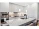 Close up of a kitchen island with stainless steel appliances and sleek white cabinets at 1901 Wazee St # 504, Denver, CO 80202