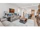 Bright living room with a modern rug and a view into the open-concept kitchen and dining area at 1901 Wazee St # 504, Denver, CO 80202