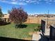 Private backyard with a new wood fence, mature trees, and a well-manicured lawn at 51 W 6Th Pl, Byers, CO 80103