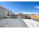 Backyard featuring a wooden deck, sliding glass doors, and snow-dusted landscaping for outdoor living at 51 W 6Th Pl, Byers, CO 80103