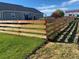 Home's fenced backyard features a well-maintained lawn and mature trees that add privacy at 51 W 6Th Pl, Byers, CO 80103
