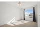Sunlit bedroom with neutral carpet, a ceiling fan, and a large arched window showing beautiful sky at 51 W 6Th Pl, Byers, CO 80103