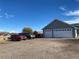 Spacious two-car garage with an extended driveway and parking, offering ample space for vehicles and storage at 51 W 6Th Pl, Byers, CO 80103