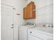 Functional laundry room with washer, dryer, and storage at 51 W 6Th Pl, Byers, CO 80103