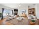 Bright living room with vaulted ceiling, fireplace, and modern furnishings at 51 W 6Th Pl, Byers, CO 80103