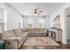 Spacious living room with corner sectional and fireplace at 14063 Jackson St, Thornton, CO 80602