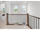 Upper landing with wooden railing and carpet at 14063 Jackson St, Thornton, CO 80602