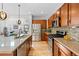 Modern kitchen featuring stainless steel appliances, granite countertops, and wood cabinetry at 3538 Akron Ct, Denver, CO 80238