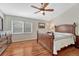 Cozy bedroom showcasing hardwood floors, a ceiling fan, and a wooden dresser with lots of storage space at 9057 Bear Mountain Dr, Highlands Ranch, CO 80126