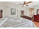 Inviting main bedroom boasting a ceiling fan and access to an ensuite bathroom through classic French doors at 9057 Bear Mountain Dr, Highlands Ranch, CO 80126