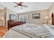 Comfortable main bedroom showcasing a dresser, ceiling fan, and a window providing lots of natural light at 9057 Bear Mountain Dr, Highlands Ranch, CO 80126