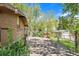 Fenced backyard with a gate and mature landscaping offering a private outdoor space with a shed at 13955 W 26Th Ave, Golden, CO 80401